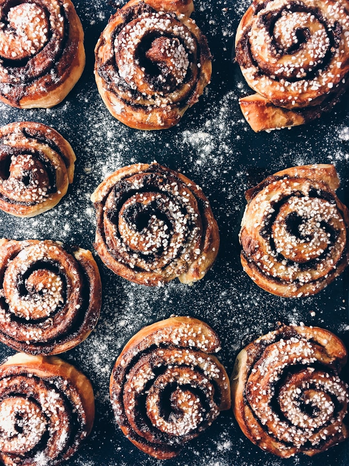Fresh cinnamon rolls with icing in a baking pan