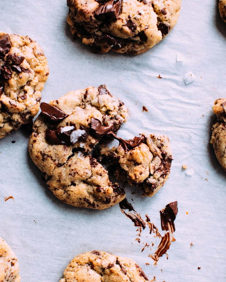 Chocolate chip cookies stacked on parchment paper