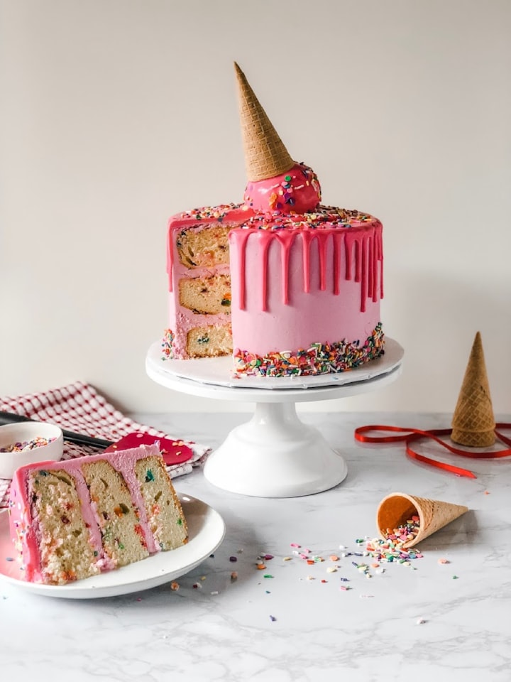 Decorated layer cake with piped frosting and fruit