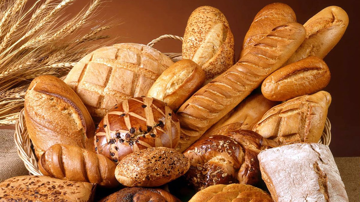 Assorted croissants and pastries on a bakery tray